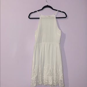white dress with lace embroidery at the bottom